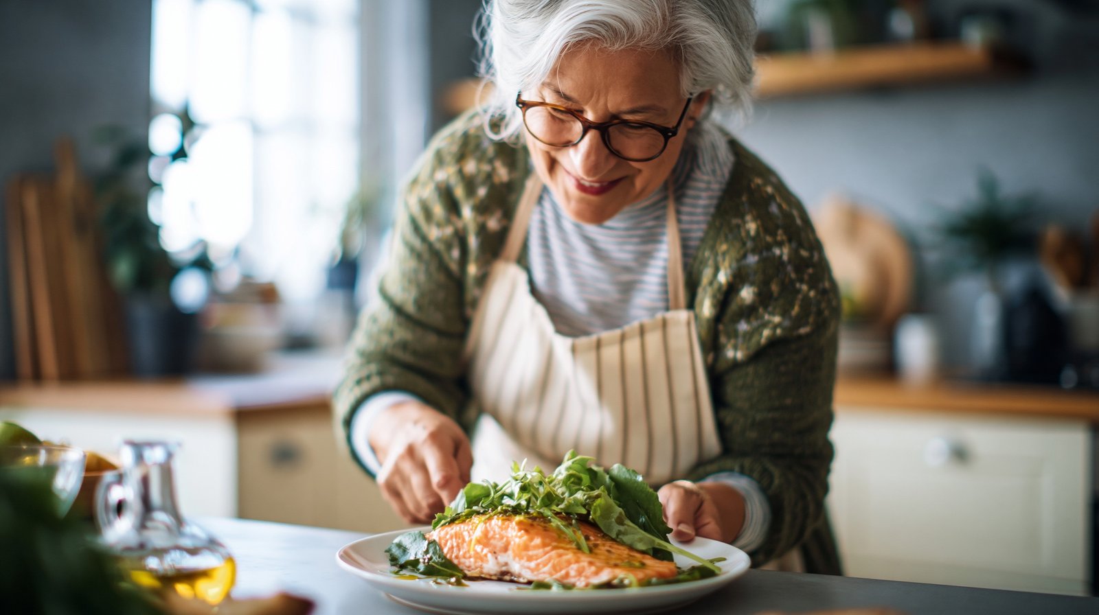 Adult woman over 55 preparing an anti-inflammatory meal of salmon and greens to support joint health.